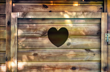 Heart shaped hole on a wooden toilet door
