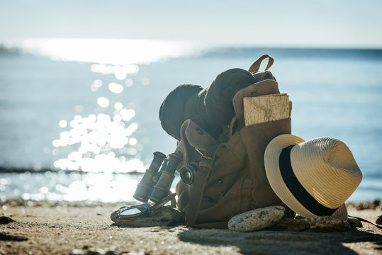 Looking image of traveling concept, essential vacation items. Background of sea. Close-up.