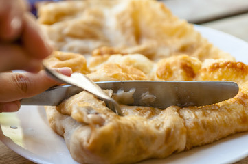 On the old table cut into cake with cheese.