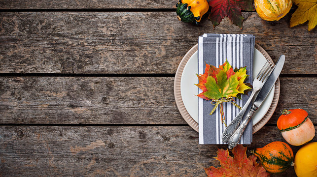 Autumn table setting with colorful leaves 