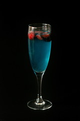 Blue cocktail standing on the table on the dark background