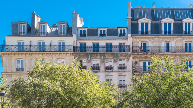 Paris, beautiful buildings boulevard de Clichy, typical parisian facades with sculptures on the stone
