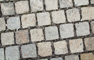 old style cobblestone pavement of grey granite stones
