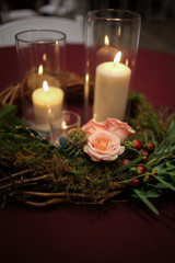 Wedding Centerpiece Candles Surrounded by a Woven Wooden Grape Vine Wreath with Moss and Pink Roses