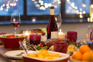 christmas dinner and eating concept - food and drinks on table at home