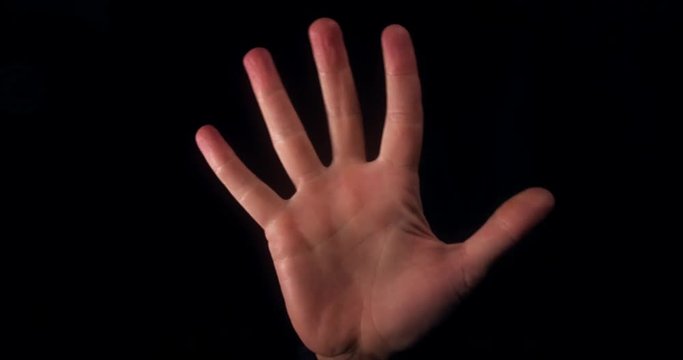 Human hand raised in stop sign