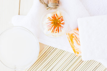 Spa and wellness setting with oil and yellow flower