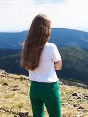 young woman in the mountains Karkonosze, the view of Śnieżka Mountain