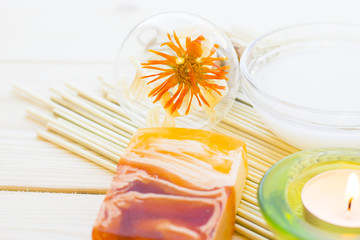 Spa and wellness setting with oil and yellow flower