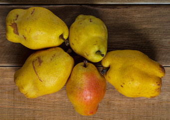 Closeup of delicious fresh autumn sweet pears on wooden table. yellow fruits. vegetarian