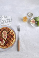 Belgian waffles Slow food breakfast concept figs raspberries honey Espresso coffee white wooden background Flat lay Copy space