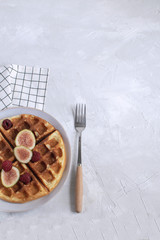 Belgian waffles Slow food breakfast concept figs raspberries white wooden background Flat lay Copy space Minimal