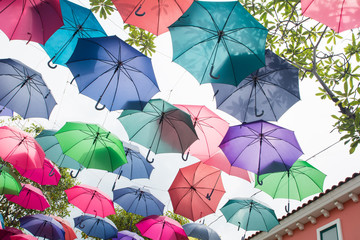 Fototapeta na wymiar Beautiful display of colorful hanging umbrellas in a outdoor, Colorful hanging umbrellas on white sky background in Sunny day