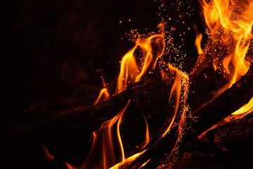 Fiery fire isolated on black isolated background . Beautiful yellow, orange and red fire flame texture style.