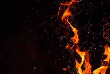 Fiery fire isolated on black isolated background . Beautiful yellow, orange and red fire flame...