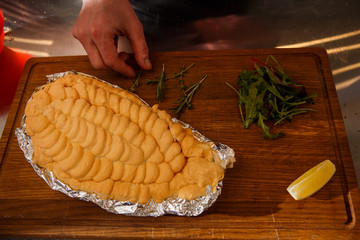 tasty baked dorado under egg whites with herbs