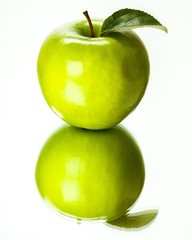 Green Apple With Leaf With Its Reflection Against Light