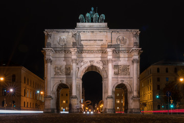 Fototapeta na wymiar The Siegestor Victory Arch in Munich. Triumphal arch at night on a rainy day. Front view.