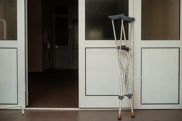 Crutches are near the doors of the hospital