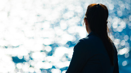 the girl looks at the river