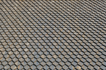 Old gray roof background made of tarred square tiles.