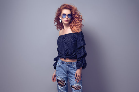 Adorable Redhead woman in Studio. Trendy Outfit