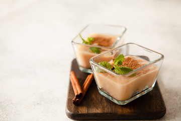 Cashew vegan cake with apple mousse and cinnamon in portion bowls decorated with mint overhead