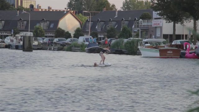 Father and Daughter Playing in River / Water