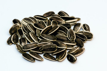 pile of sunflower seeds on white background