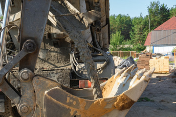 workers poured concrete into a wooden formwork