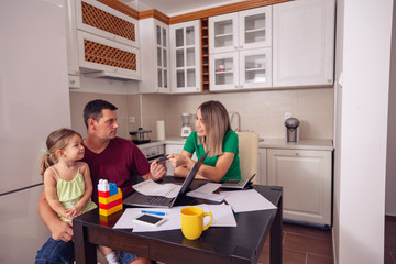 young couple calculating bills at home.