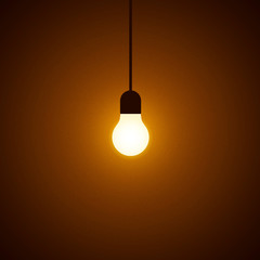 Turning on light bulb with particles on dark background