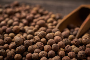 Allspice on a gray wooden background, close-up