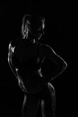 Fototapeta na wymiar Monochrome bodyscapes of a fit tattooed woman