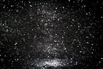Black background for christmas navy glitter sparkle. Abstract bokeh light shiny dark holiday.