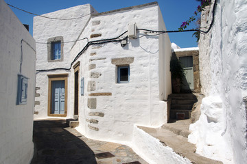 Fototapeta na wymiar A view of streets and ancient houses in the island of Patmos, Greece in summer time