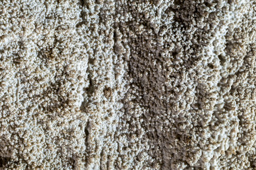 Dark cave view from inside with a lumen. Stalactites and stalagmites inside the stone grotto. Colorful stones in the cave. Lighting electricity beauty of the cave.