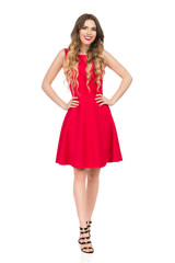 Smiling Beautiful Young Woman In Red Mini Dress Is Holding Hands On Hip