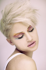 Fashion beautiful blonde woman with short haircut and colorful make up