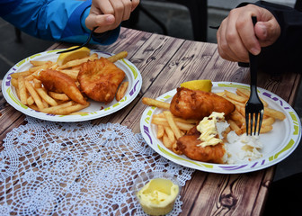 Eating fish and chips  in the centre of Alesund , Norway.