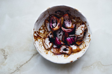 red sweet onion in white bowl marinated in wine vinegar Top view