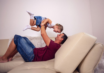 Playful young family - Smiling father and daughter having fun together.