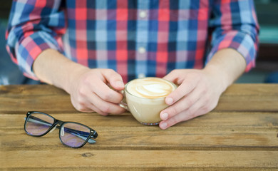 A Cup of coffee in men's hands