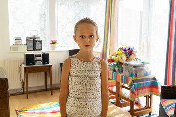 Portrait of a female child in a colourful old style dinning room