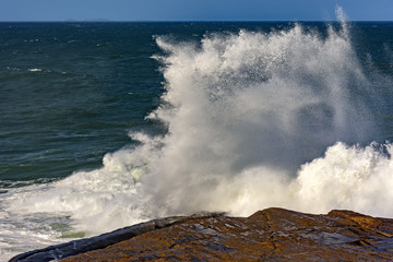 Storm wave breaking on the rocks of Ipanema beach in Rio de Janeiro