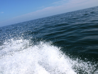 Water Spray. Spray Of Sea/Salt Water From A Boat On A Blue Sea With Blue Sky