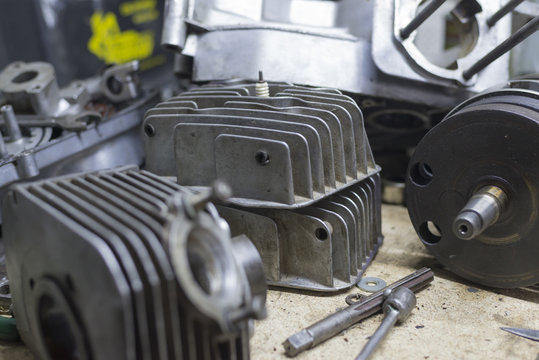 Motorcycle parts and tools on the desktop in garage
