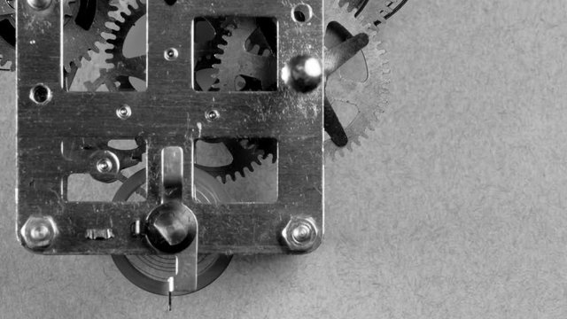 Black and white close up detail of running clock or watch machinnery . Copy space available and suitable for time concepts