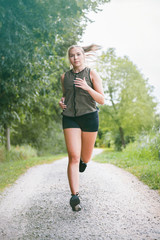 blonde sports woman jogs in park