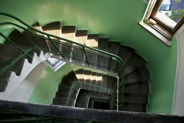 Downward spiral staircase in old building. Indoor residential staircase, built in 1930, Kaunas,...